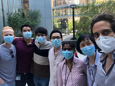 The lab team poses in masks